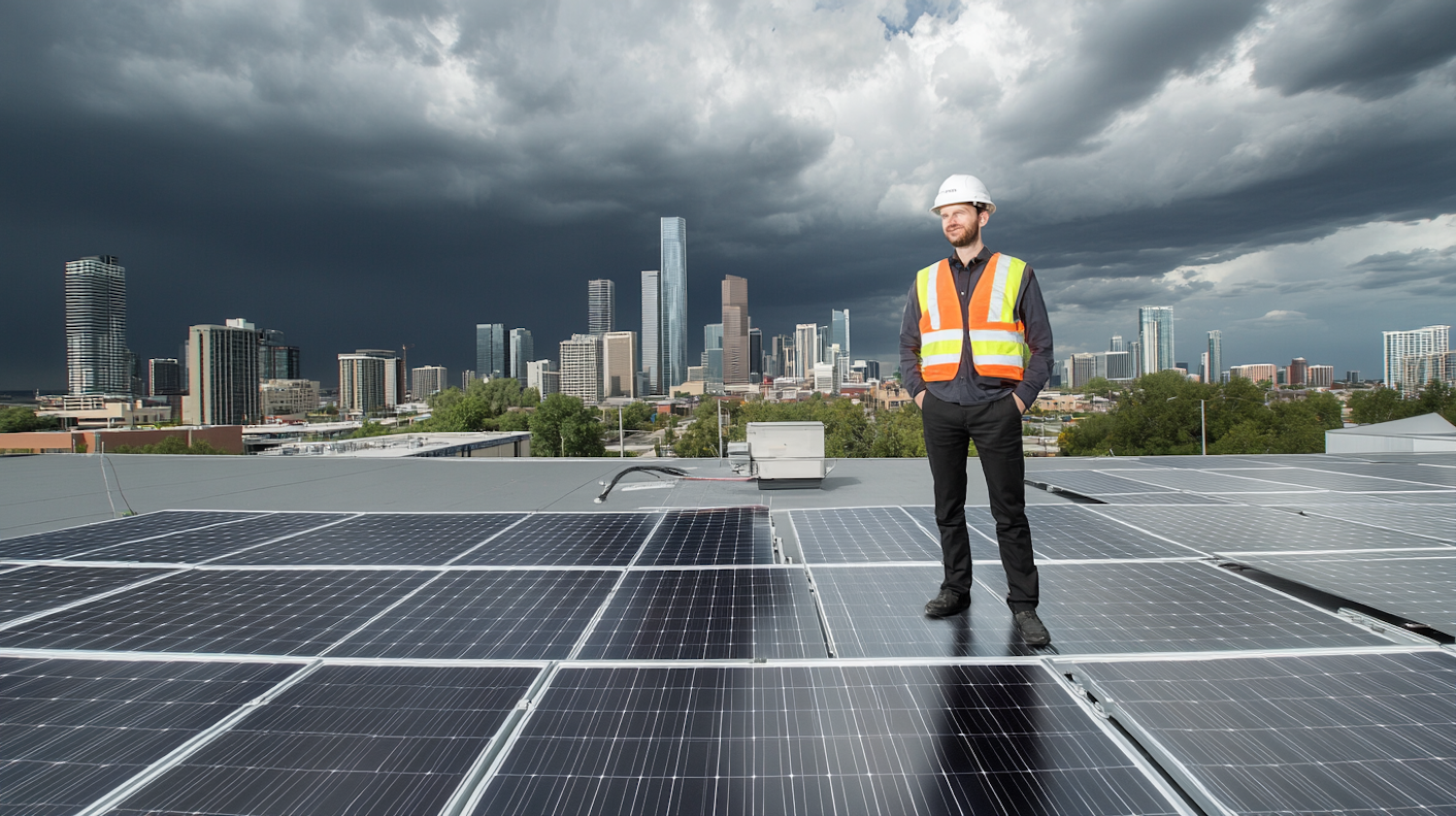 Man on Rooftop with Solar Panels