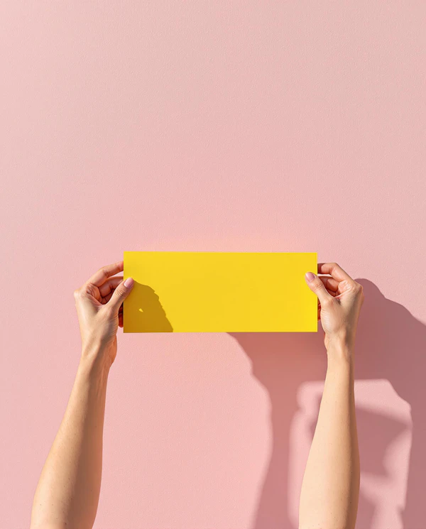 Hands Holding Yellow Object