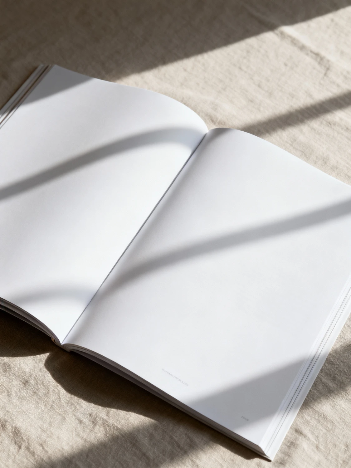An open book resting on a beige fabric surface