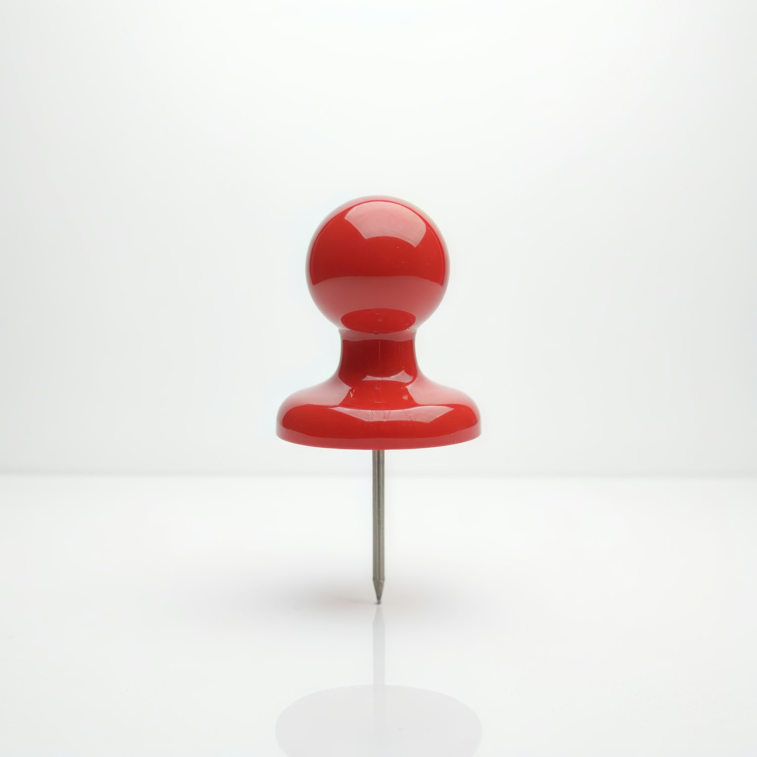 Red Pushpin on Light Background