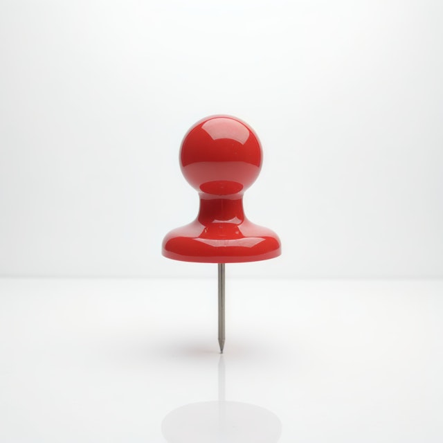 Red Pushpin on Light Background