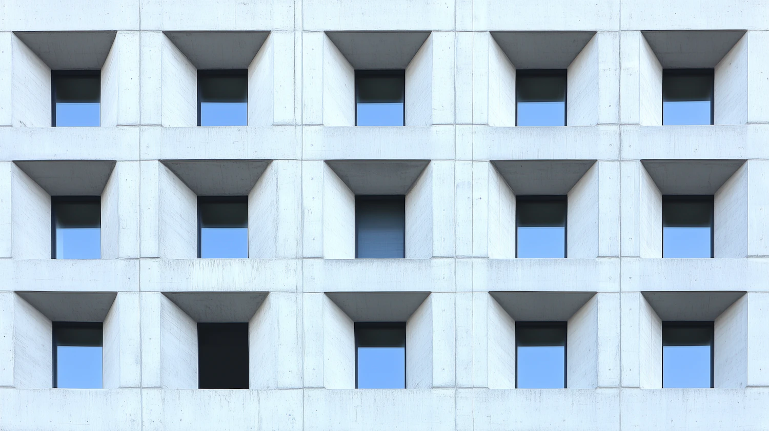 Modern building facade with a grid of recessed square windows
