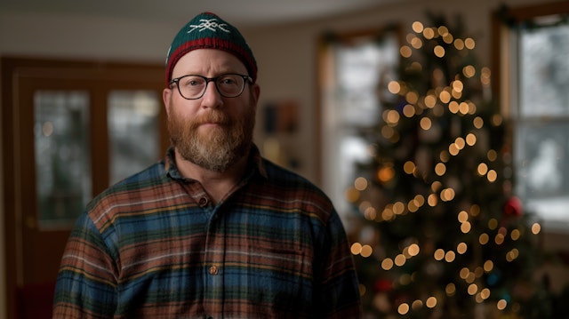 Man in Plaid Shirt with Christmas Tree