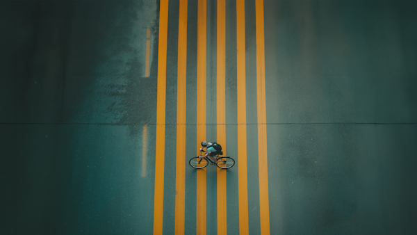 Lone Cyclist on a Moody Path