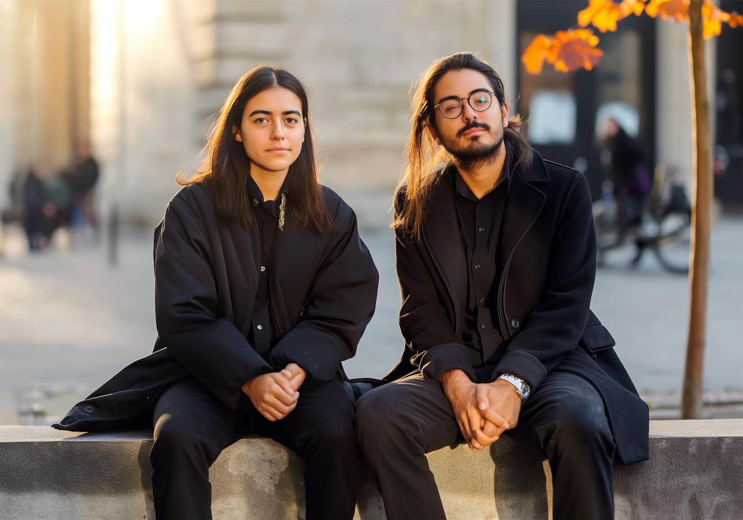 Two Young Individuals in Black Attire with Cityscape Background