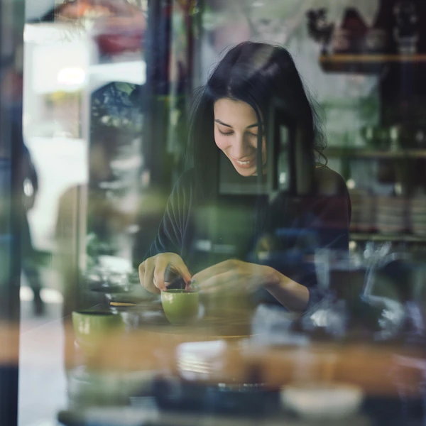 Woman engaged in a creative or culinary activity inside a cafe