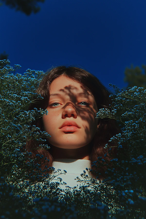 Woman Amidst Blue Flowers