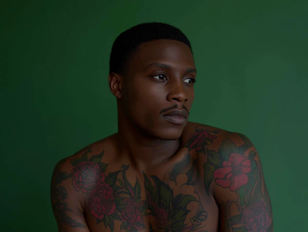 Contemplative Tattooed Man