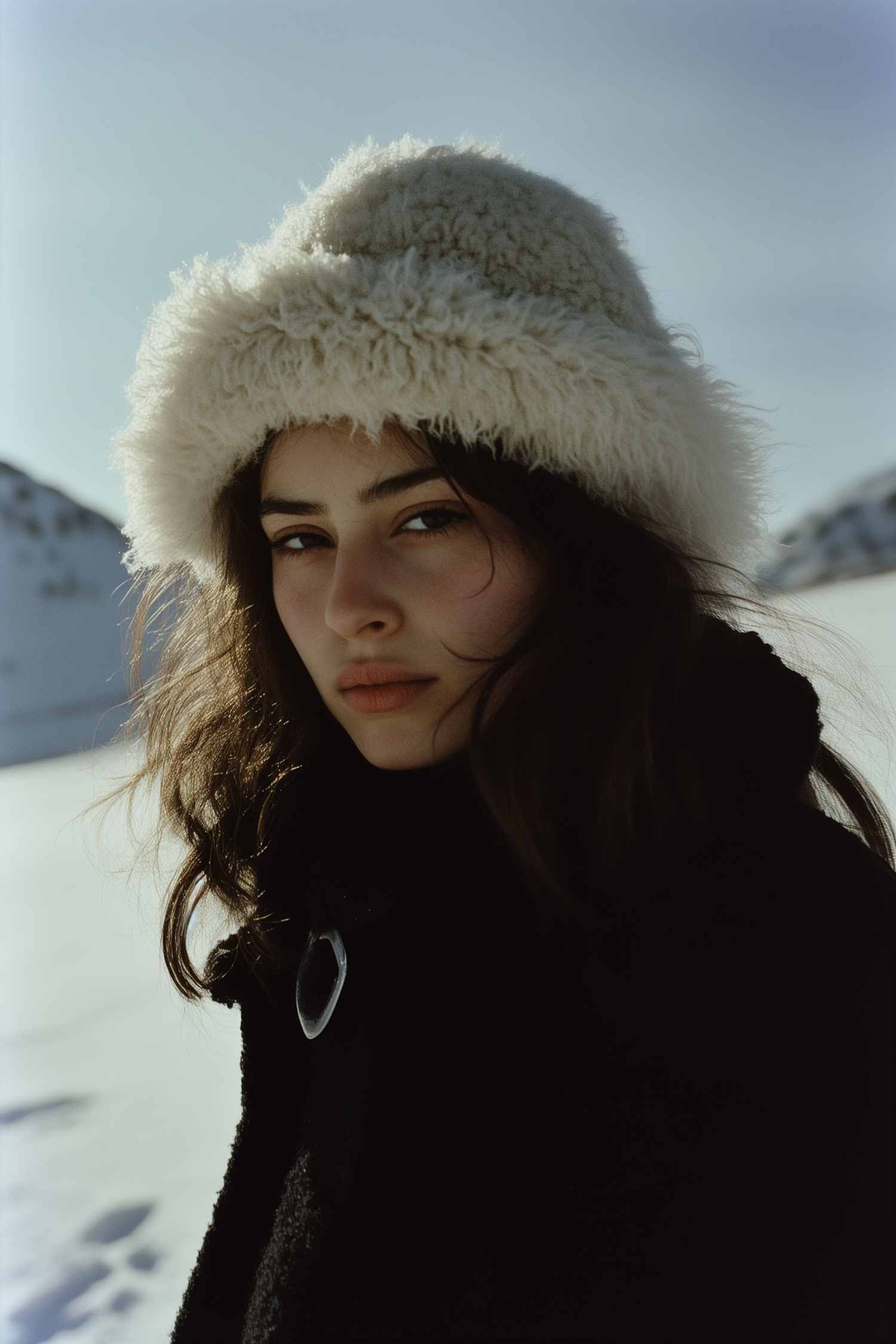 Contemplative Woman in Snowy Mountains