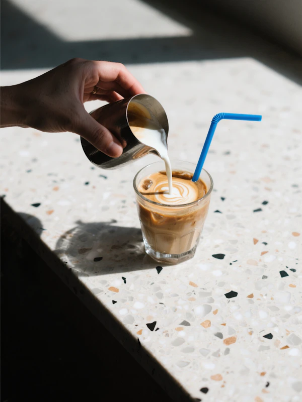 Milk Pouring into Coffee