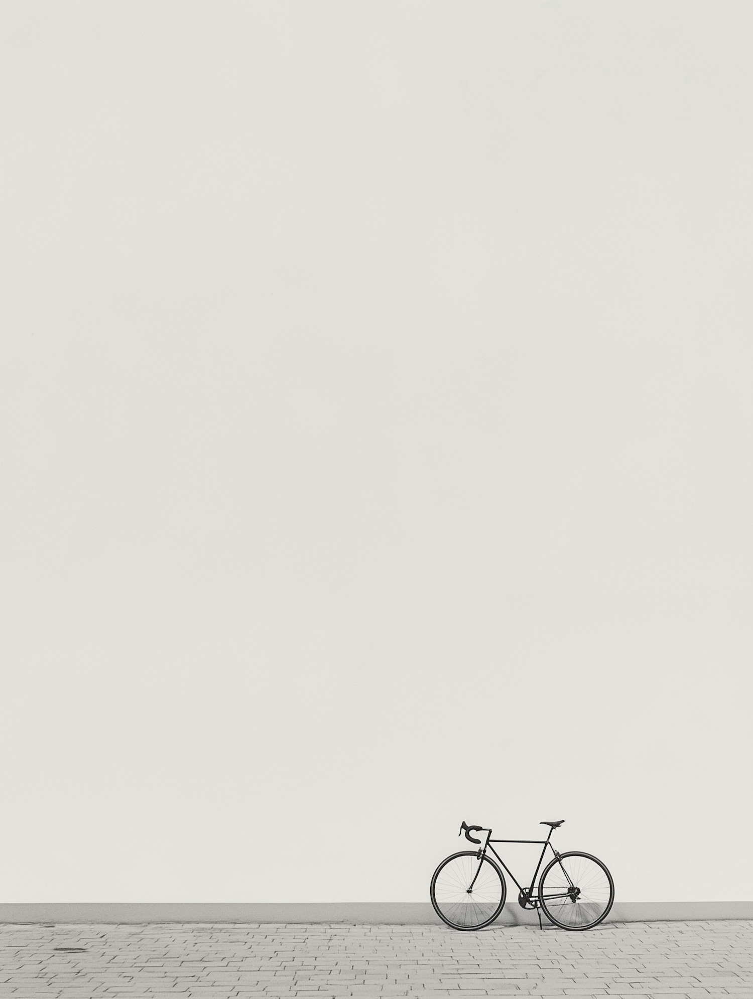 Solitary Bicycle Against White Wall