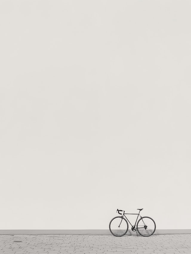 Solitary Bicycle Against White Wall