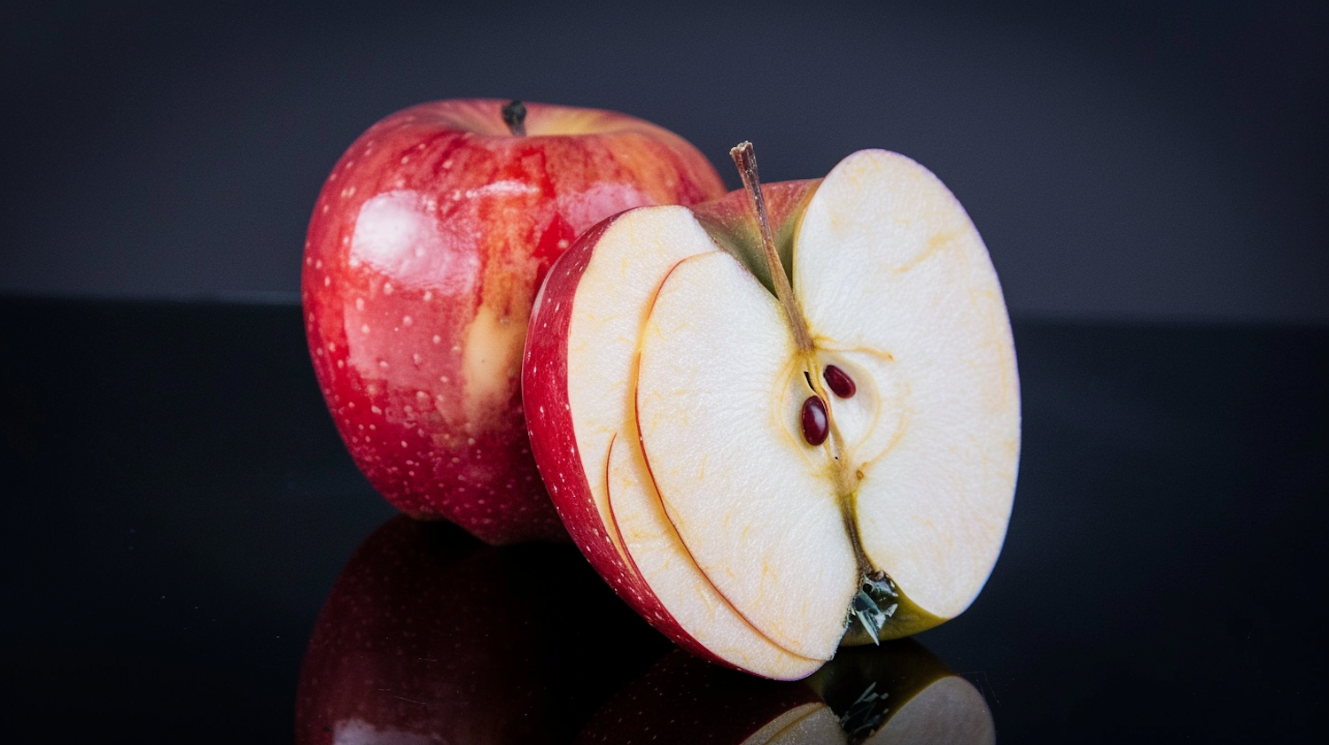 Red Apple on Reflective Surface