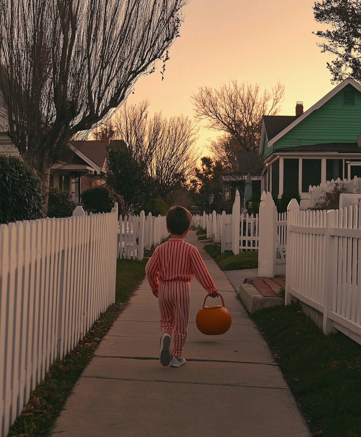 Child Walking at Sunset in Halloween Pajamas