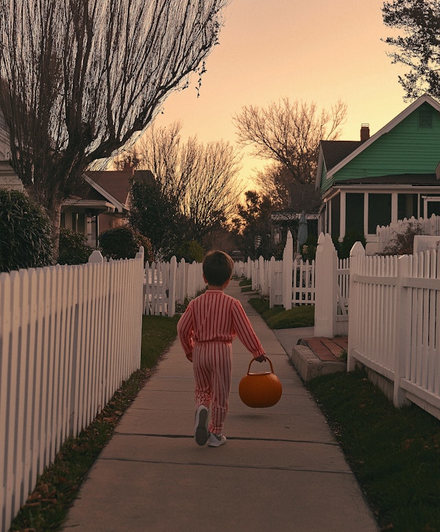 Child Walking at Sunset in Halloween Pajamas