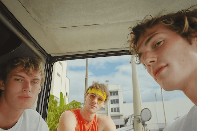 Three Young Men in a Vehicle