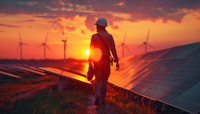 Technician Walking in Solar Farm at Sunset