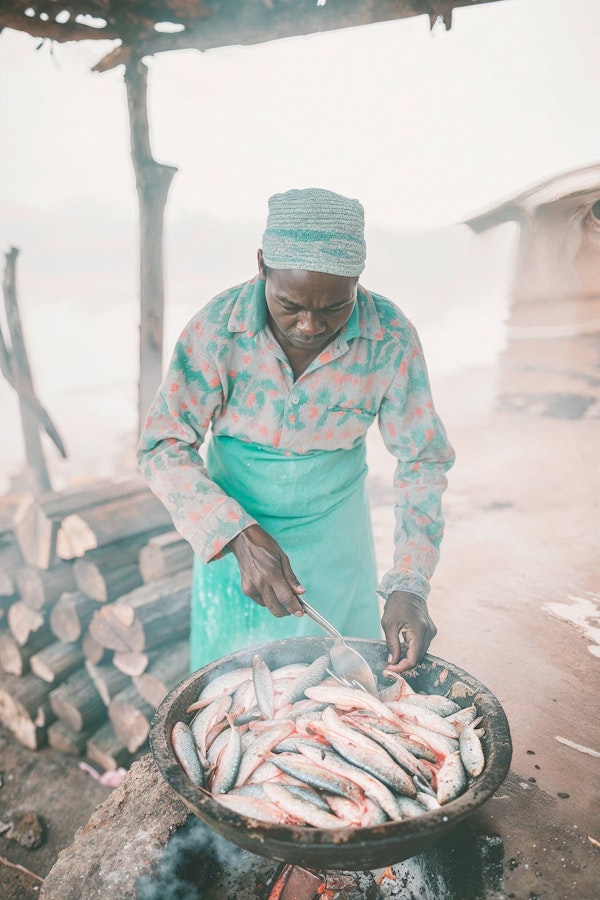 Man Cooking Fish Outdoors