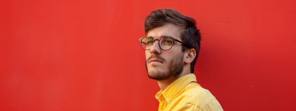 Man in Yellow Against Red Wall