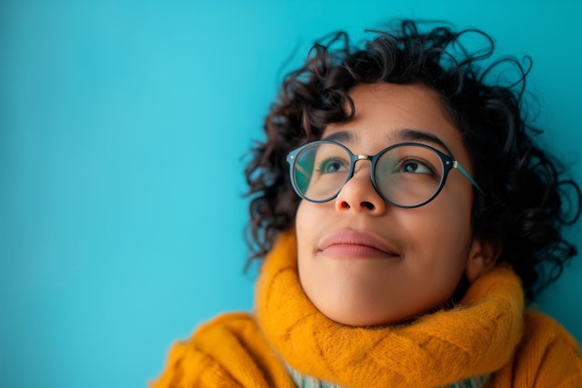 Contemplative Young Person with Curly Hair