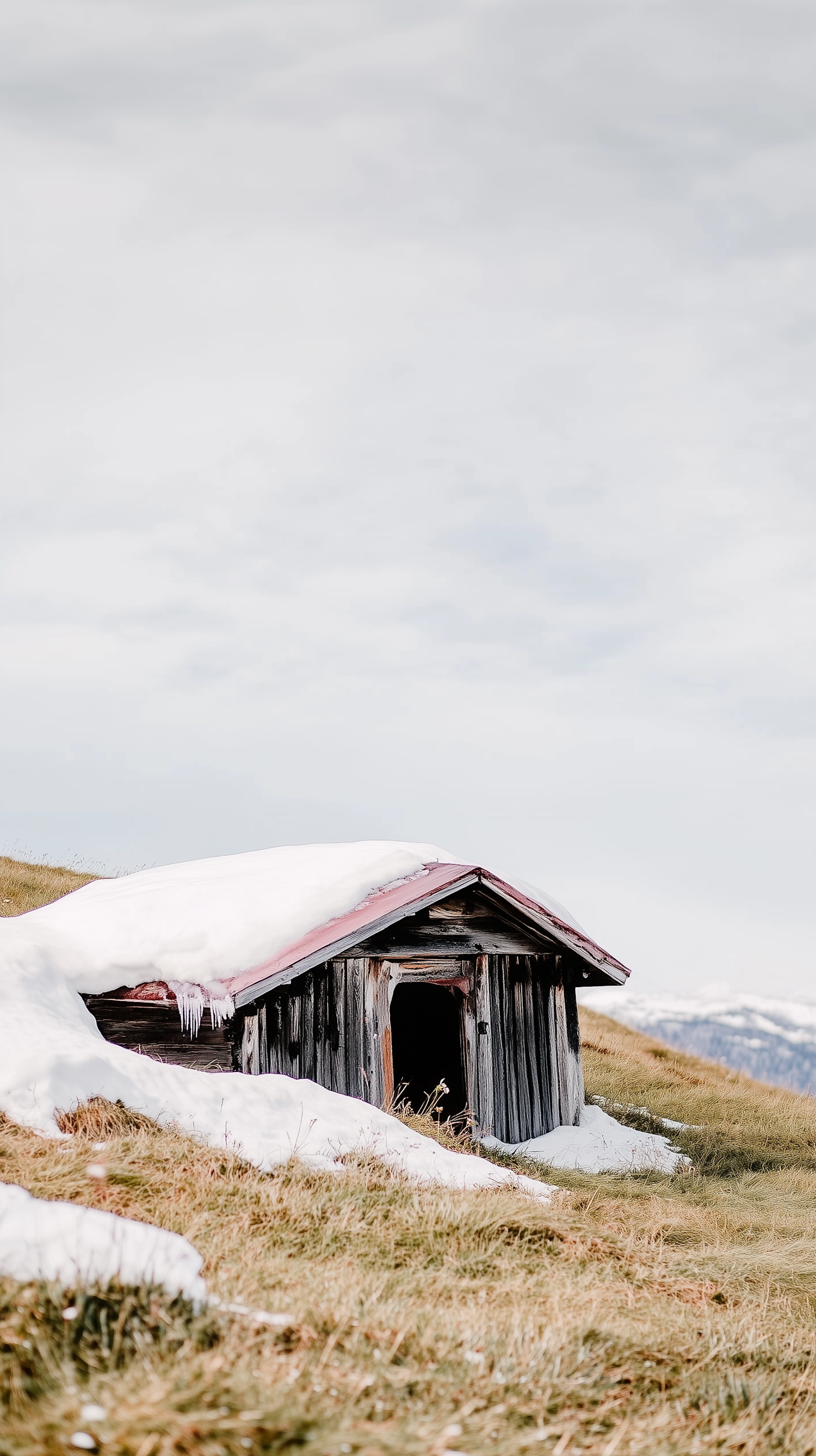 Rustic Cabin in Snowy Landscape