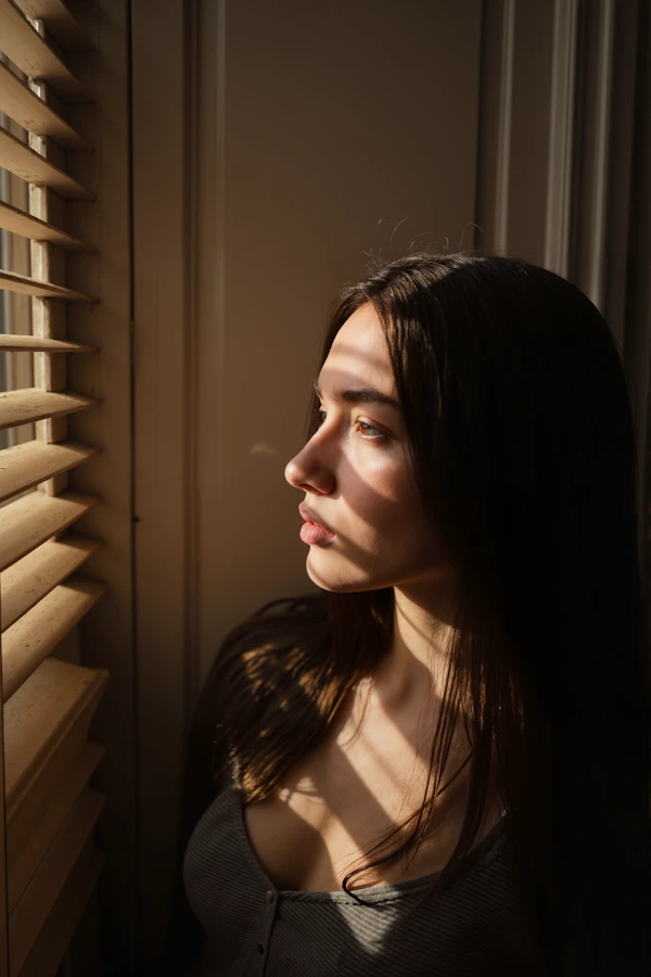 Woman in Sunlit Window