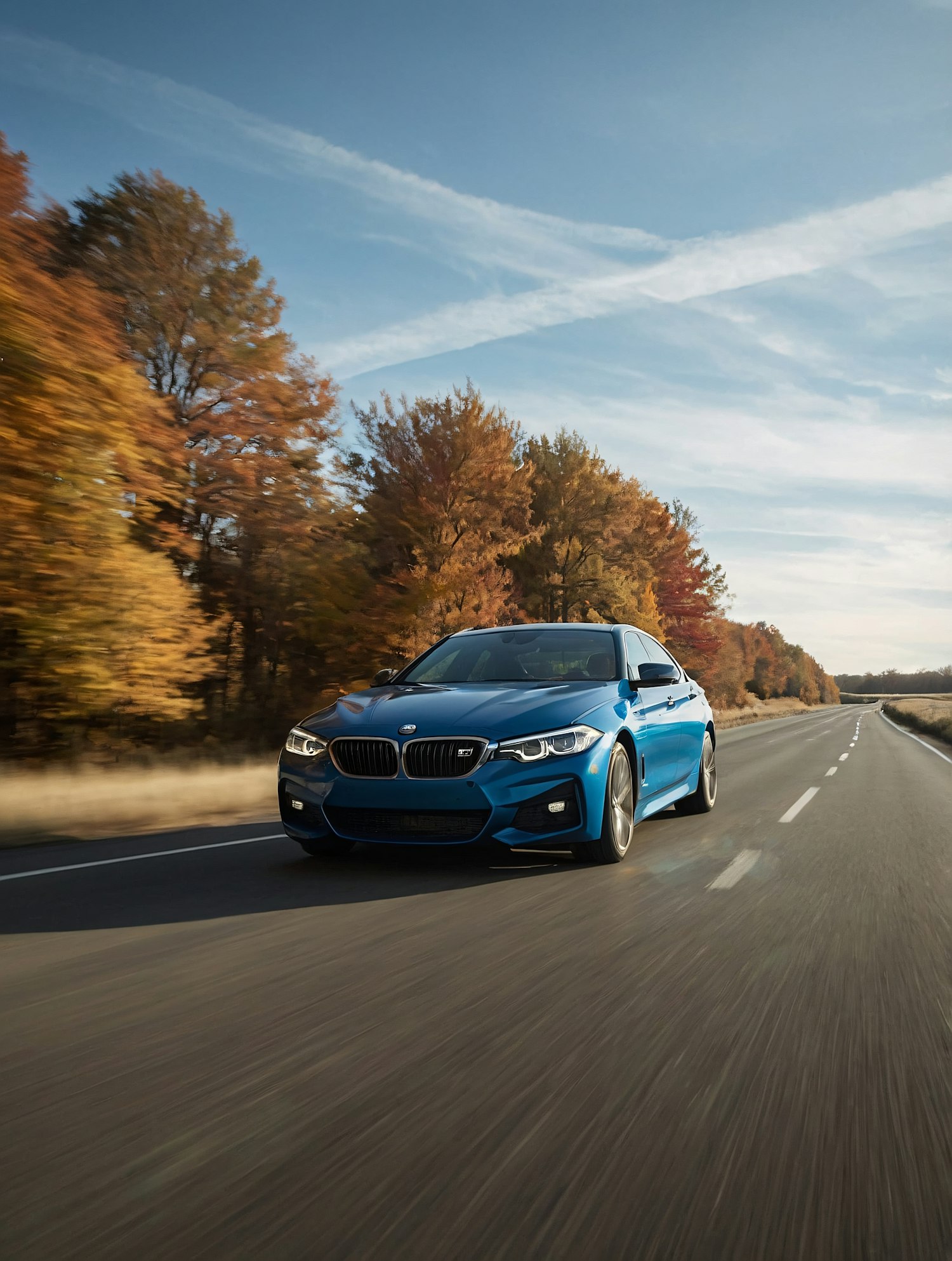 Blue Car on Autumn Road