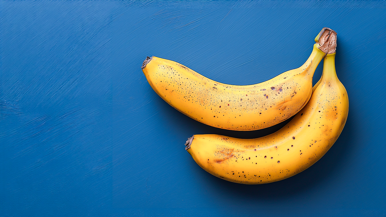 Vibrant Yellow Bananas on Blue Background