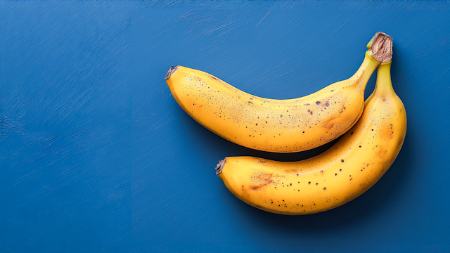 Vibrant Yellow Bananas on Blue Background