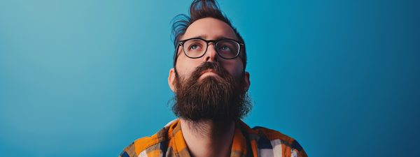 Contemplative Hipster Man with Beard and Glasses