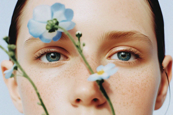 Close-up of Face with Blue Eyes and Flowers