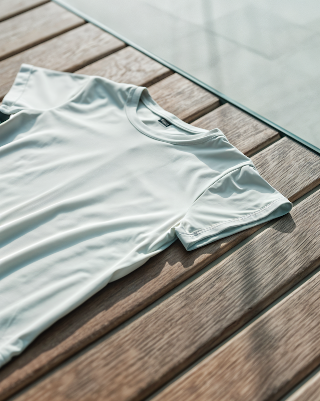 White T-shirt on Wooden Surface