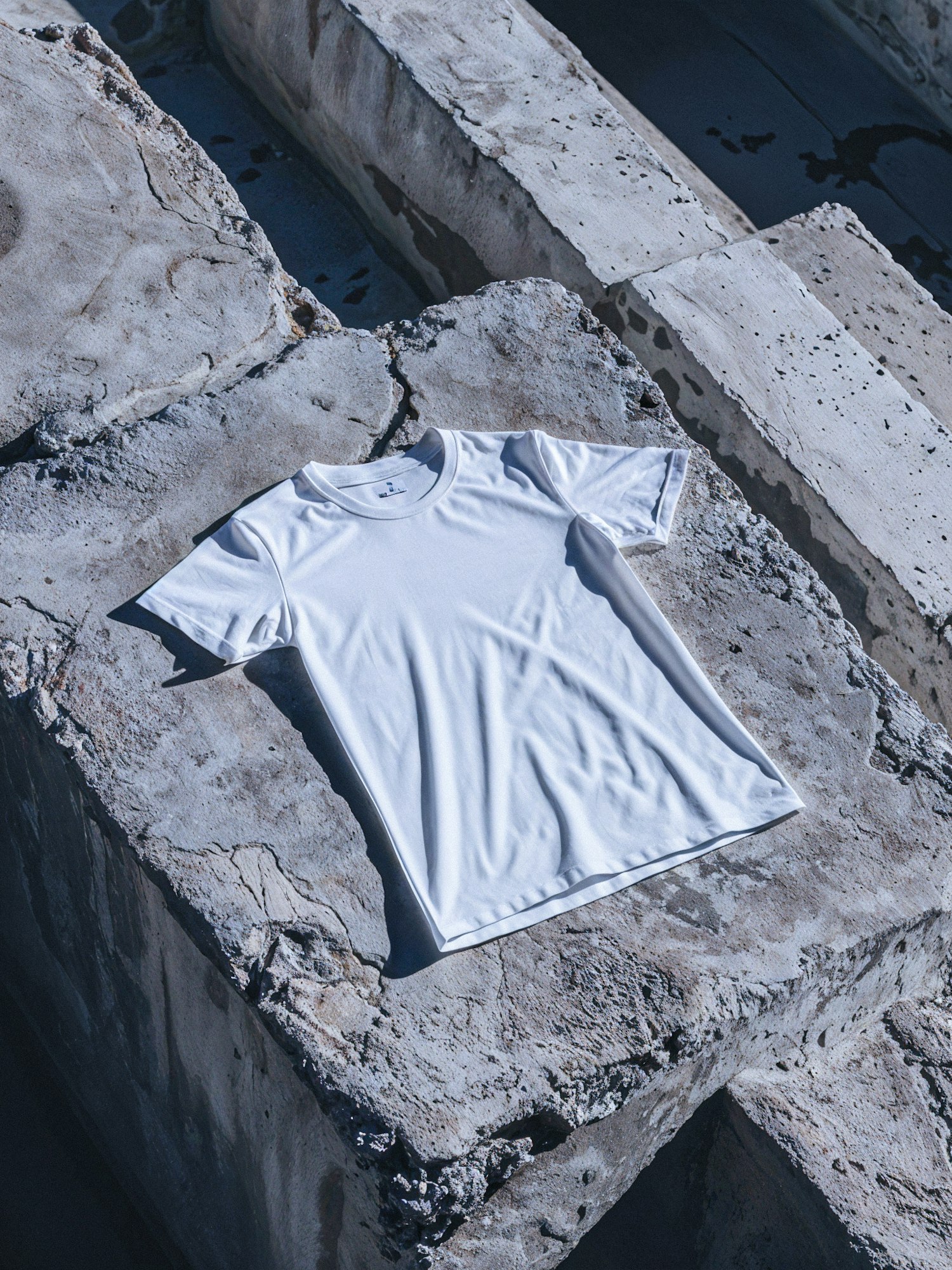 White T-shirt Mockup on Textured Concrete