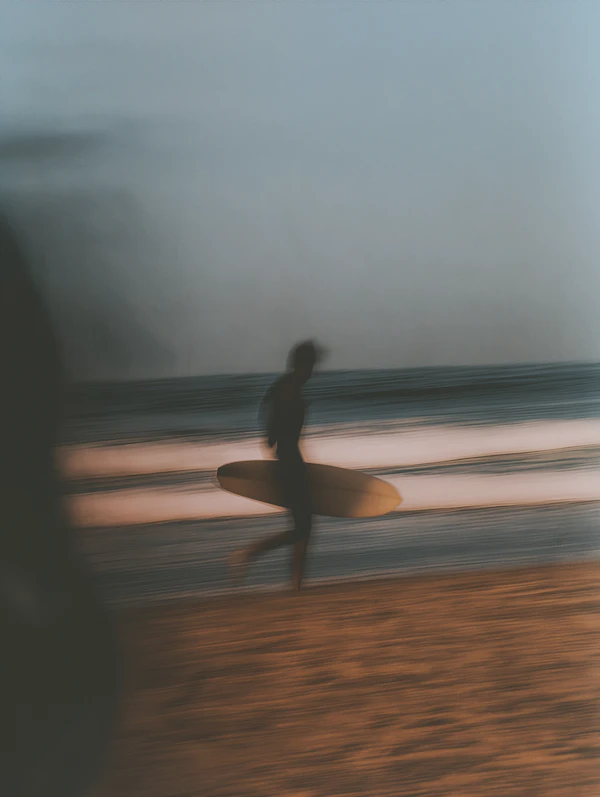 Silhouette of Surfer on Beach
