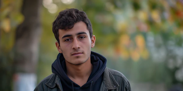 Portrait of Thoughtful Young Man with Autumn Backdrop