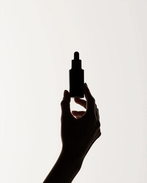 Hand with Dropper Bottle