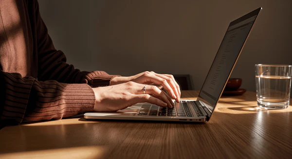 Person Typing on Laptop