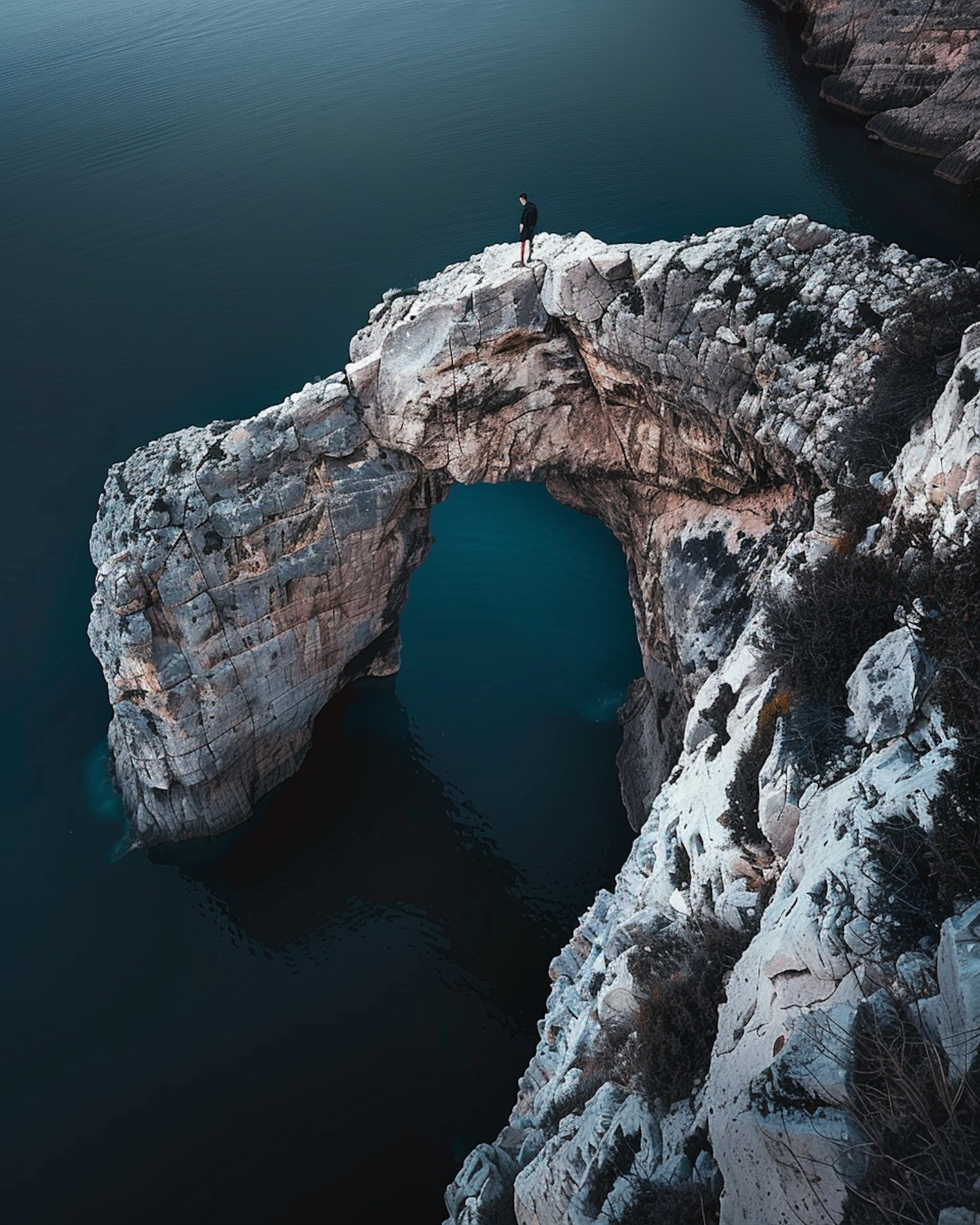 Solitary Figure on Natural Arch