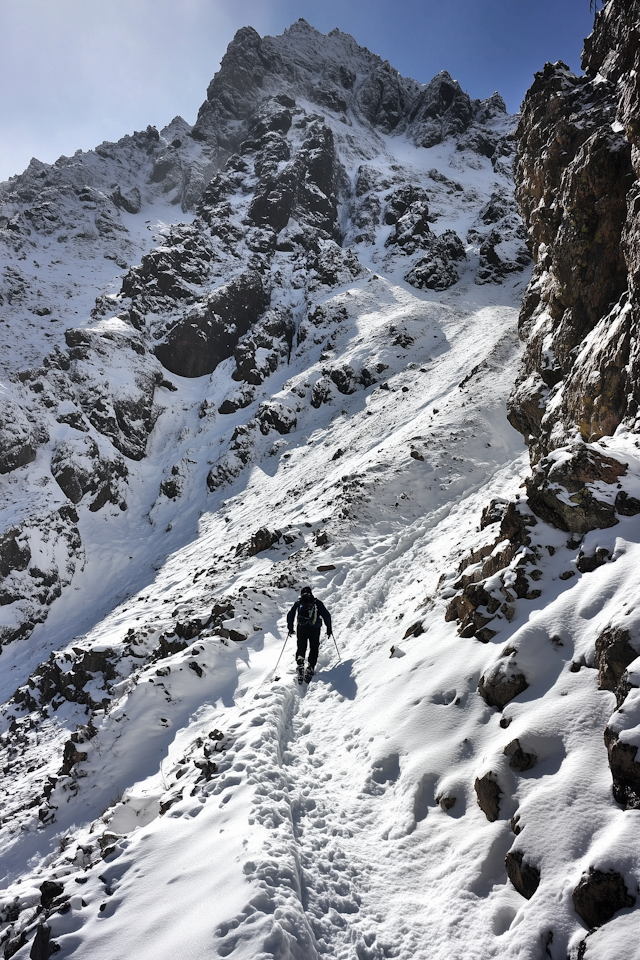 Lone Hiker on Snowy Mountain