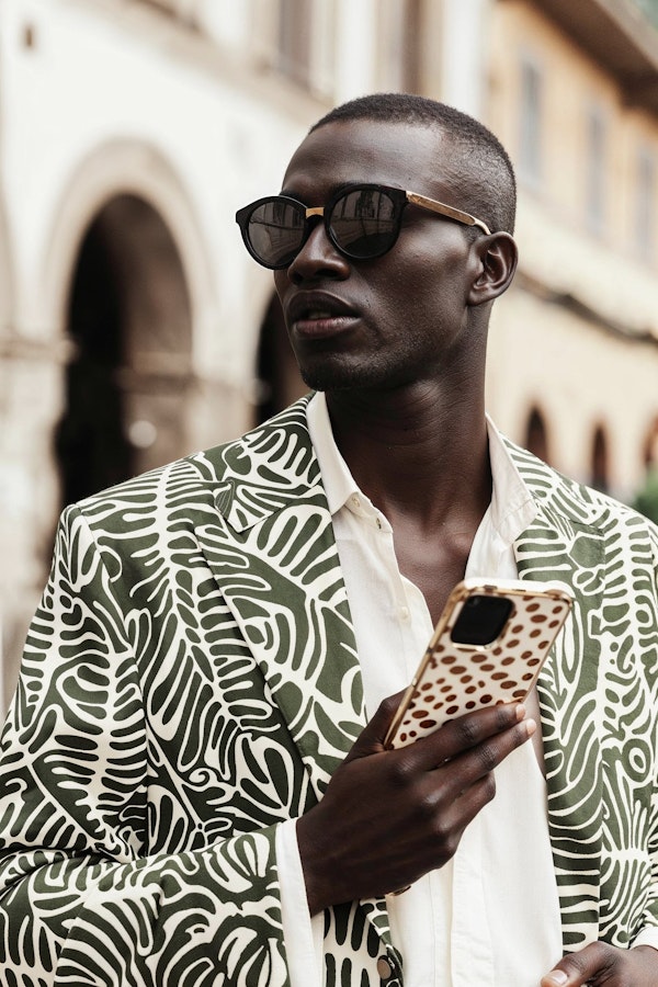 Fashionable Man in Urban Setting with Smartphone