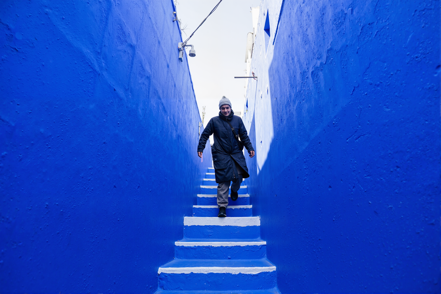 Person Descending Blue Stairs