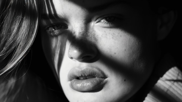 Monochrome Portrait of Young Woman with Dramatic Lighting