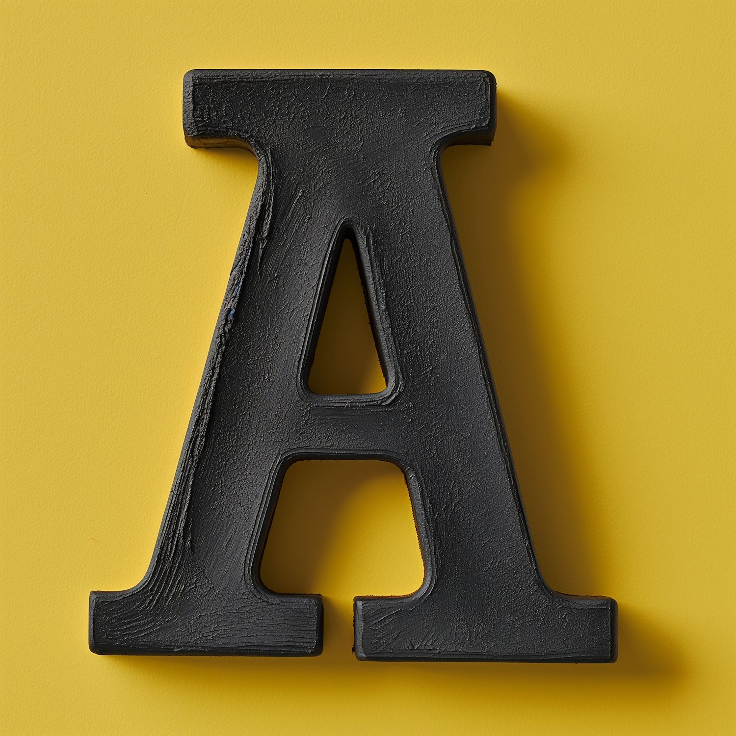 Bold Black Letter A on Yellow Background