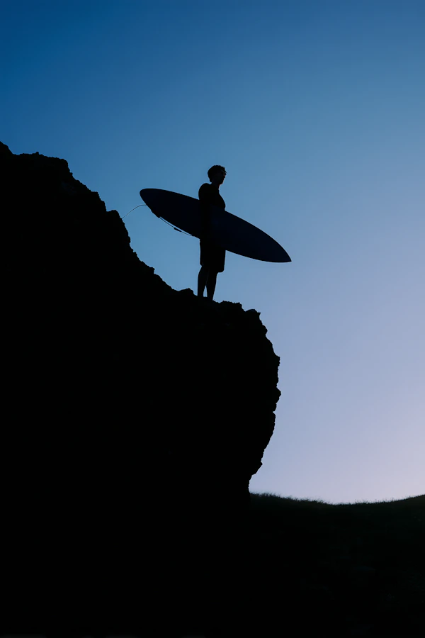 Surfer on Cliff Silhouette
