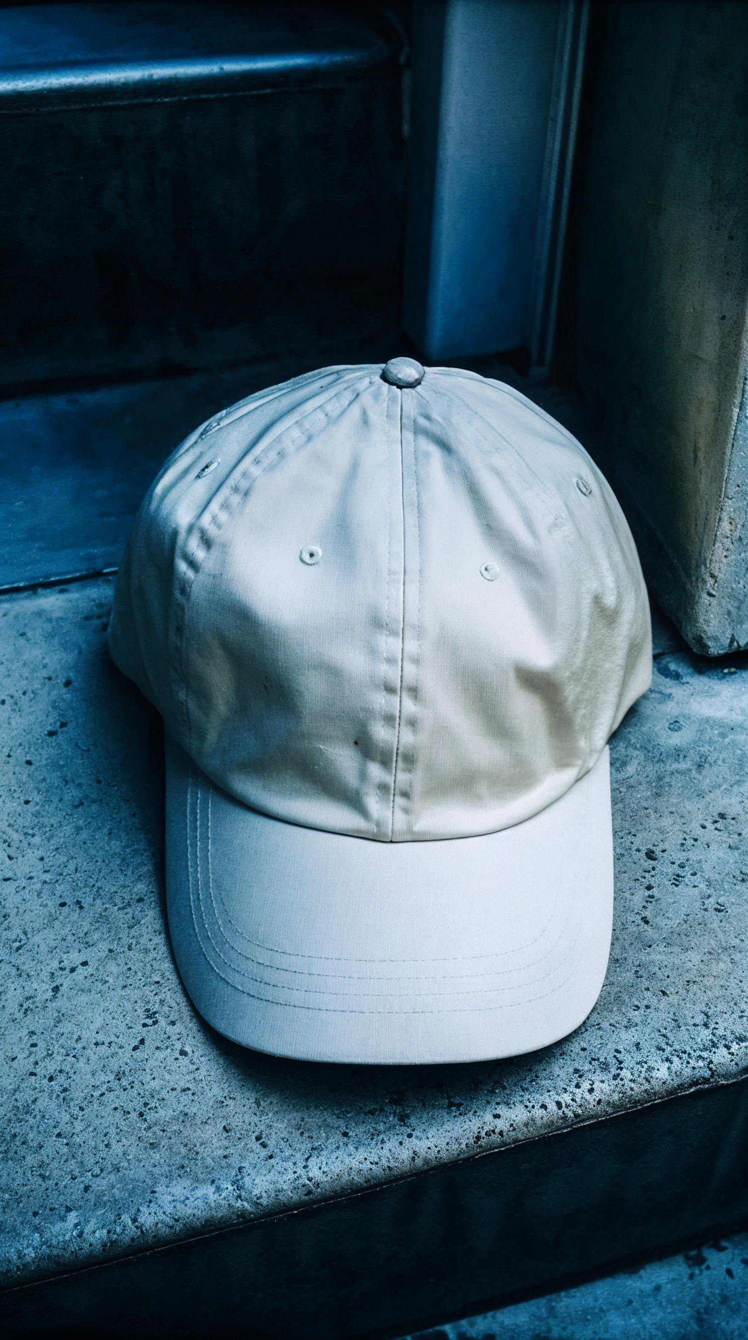 Beige Baseball Cap on Concrete Step