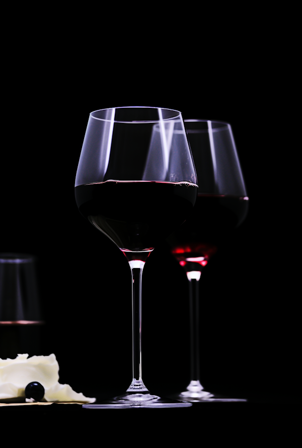 Elegance in Crimson: Dual Wine Glasses in Intimate Ambiance