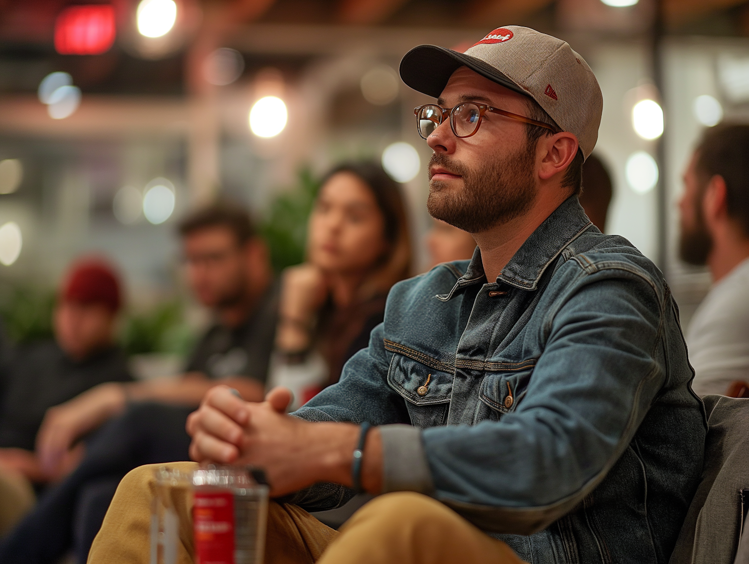 Contemplative Man in Casual Style at Social Gathering