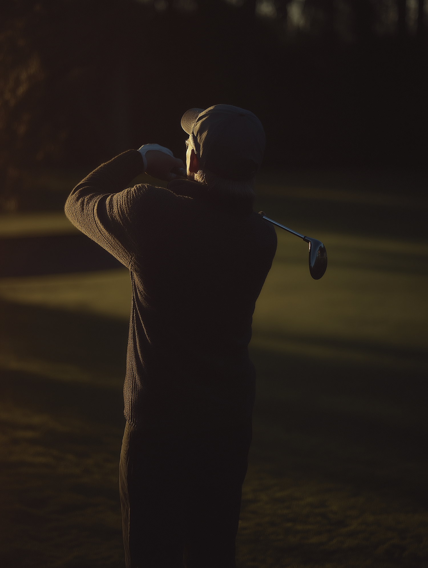 Silhouetted Golfer in Action