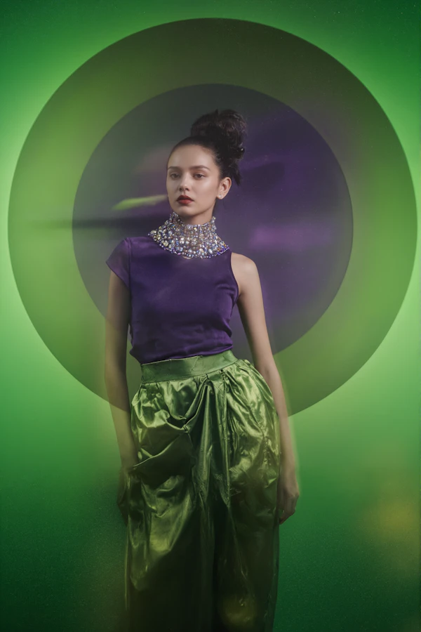 Fashionable Woman Against Green Background