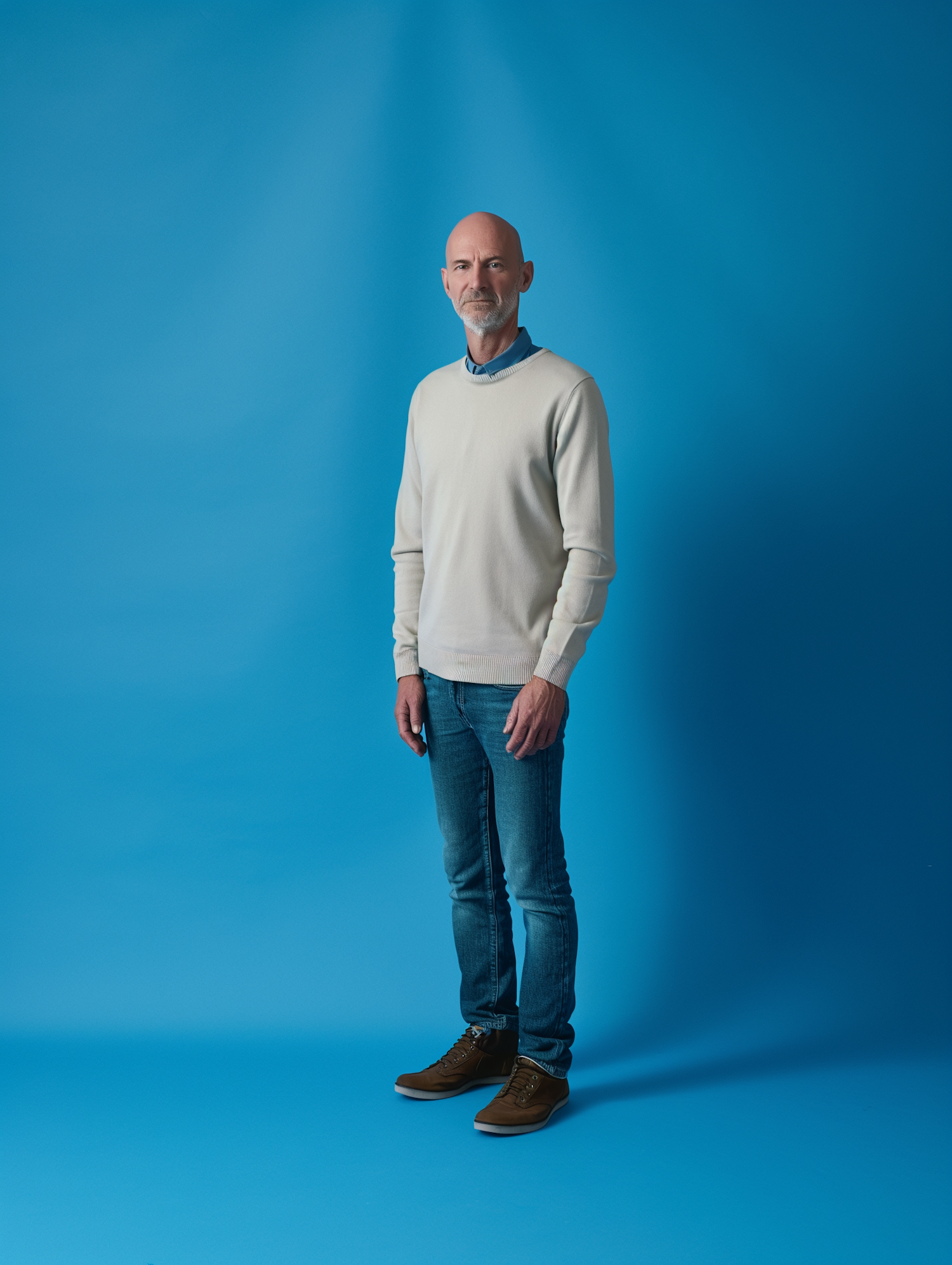 Tranquil Blue Backdrop with Gentleman in Cream Sweater and Jeans